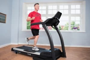 Man running on treadmill at home